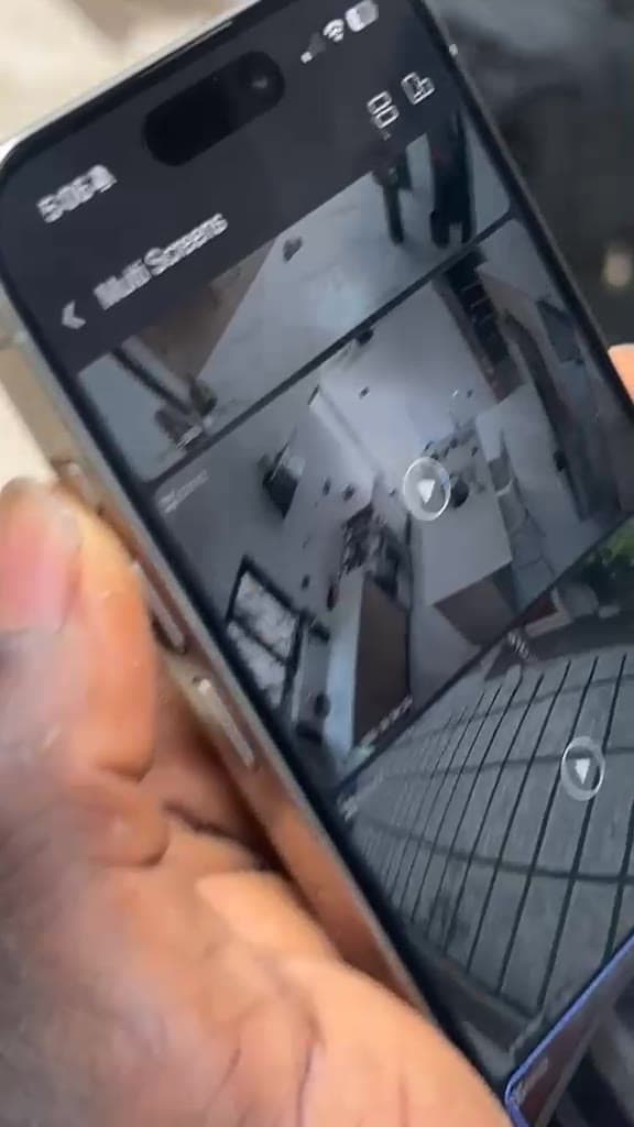 Mobile phone showing a multi-screen live CCTV view of an installed camera system