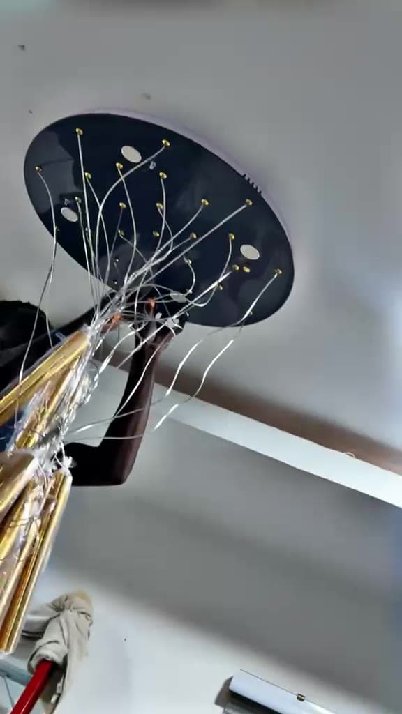 Ceiling canopy plate being wired before a pendant light fitting is mounted